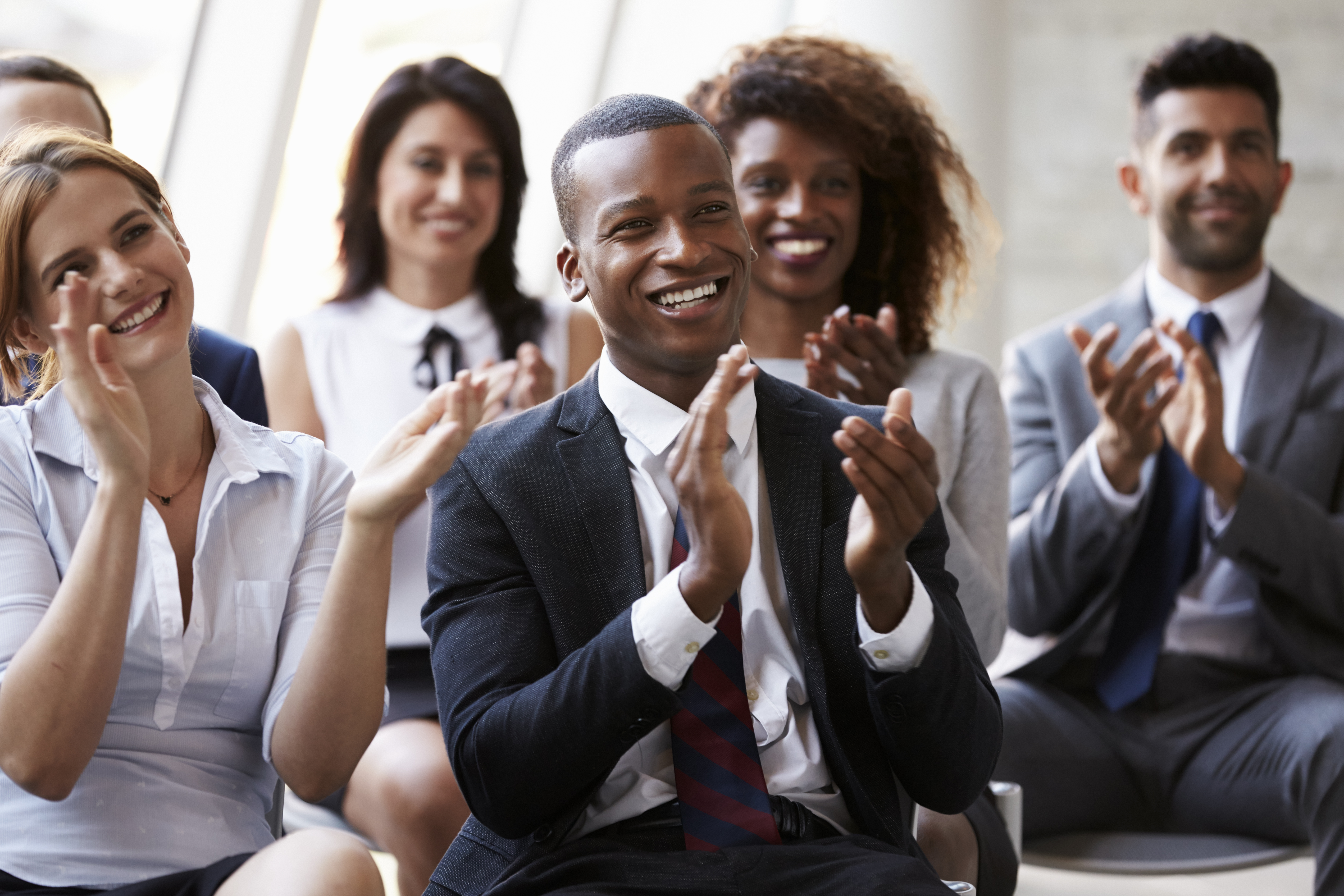 People in suits clapping